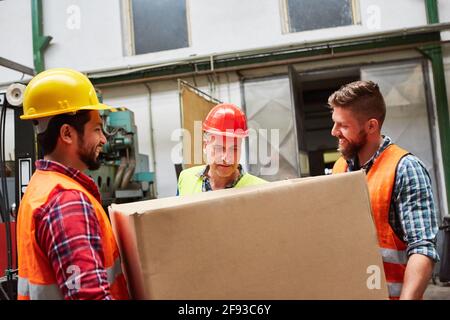 Specialist warehouse clerk and warehouse worker with parcel delivery in the receiving department of the factory Stock Photo