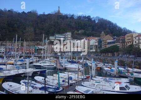 San Sebastian, Spain - April 2, 2021: Boats in the marina in La Concha Bay at the foot of Mt. Urgull Stock Photo