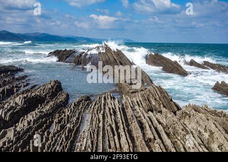 Zumaia, Spain - March 17, 2021: Flysch rock formations on the beach in Zumaia, Basque Country, Spain Stock Photo