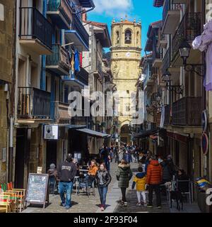 Getaria, Spain - March 19, 2021: Tourists walk through the old town of Getaria Stock Photo