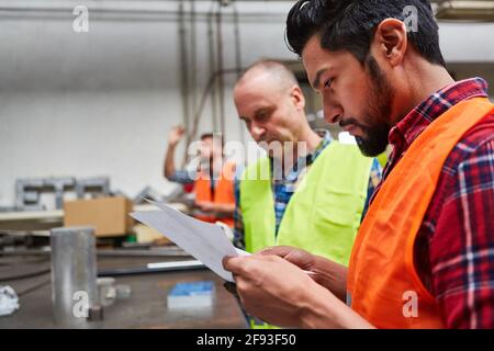 Two workers or craftsmen are planning an order or checking an order Stock Photo