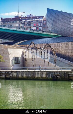 Bilbao, Spain - April 2, 2021: 'Maman' spider sculpture on display outside the Guggenheim Museum in Bilbao, Spain Stock Photo