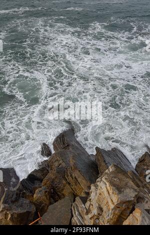 Waves crash against the rocky shores of the Basque coast. San Sebastian, Spain Stock Photo