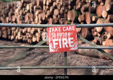 warning,sgns for logging and wood stacks on a path clearing in surrey Stock Photo
