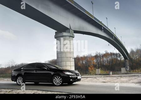 Chernihiv, Ukraine - November 5, 2018: Black car Lexus ES 350 on the background of the bridge Stock Photo