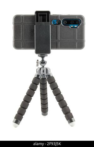 black cellphone in rugged rubber protective cover on small flexible tripod isolated on white Stock Photo