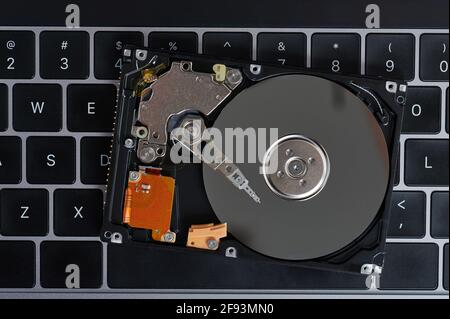 Reading data from hard drive on laptop keyboard background Stock Photo
