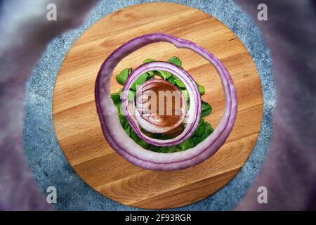 Falling rings of red onion, parsley and pepper Stock Photo