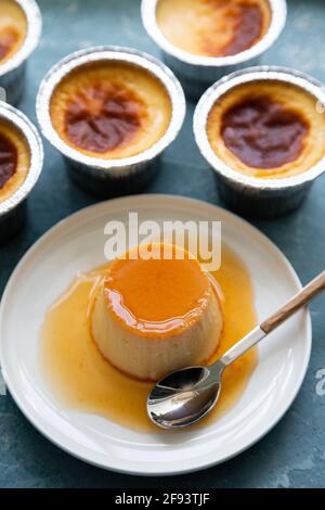 Homemade flan or creme caramel on a blue rough background