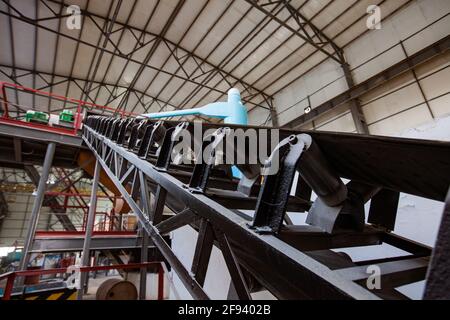 Factory workshop and glass recycling equipment.Conveyor transporter with rubber belt. Shymkent, Kazakhstan: Ferrum Vtor company. Stock Photo