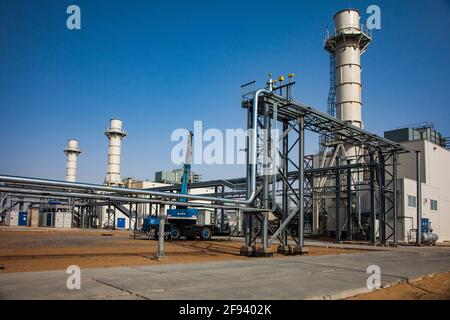 Kzylorda region, Kazakhstan: Modern gas power plant in desert. Panorama view on pipelines, smoke stacks, industrial buildings and crane. Stock Photo