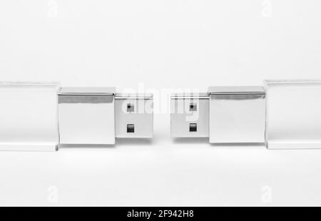 Two glass transparent USB drives with a metal insert on a grey background close-up. Copy space. A high resolution. Stock Photo