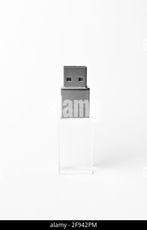 Vertical glass transparent USB drive with metal insert isolated on grey background. Layout. Copy space. A high resolution. Stock Photo