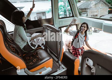 a man raised his hand to greet his friend Stock Photo