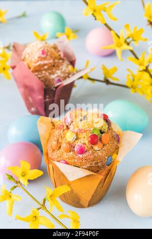 Muffins with colorful chocolate and Easter decoration, vertical Stock Photo