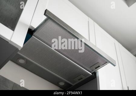 Grey stainless cooking glass hood on modern white minimalist style kitchen. Kitchen supplies. Stock Photo