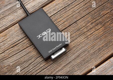 XQD card reader on a wooden background. Stock Photo