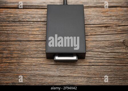 Card reader for a high-speed memory card on a wooden background. Stock Photo
