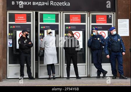 Policemen wearing face masks stand at the entrance to a metro station.Since the epidemic situation with Covid-19 coronavirus in the capital is not improving significantly, the authorities have extended the quarantine in Kiev until April 30, Kiev's mayor Vitali Klitschko said. The previously introduced restrictions will be in effect in the city until April 30. All schools and kindergartens remain closed, all public transport - ground and metro will work exclusively with special passes, catering establishments will work only for take-out and delivery. Credit: Sipa USA/Alamy Live News Stock Photo