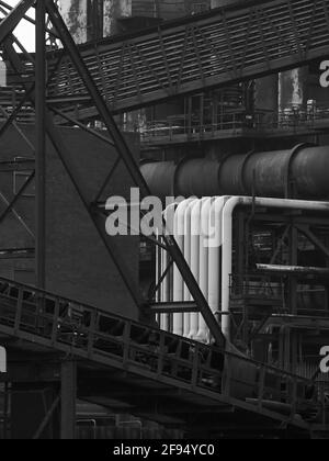 Detail from the derelict Redcar Steelworks, showing a section of the blast furnace complex, a tangle of pipes, gantries and scaffolding rusting away Stock Photo