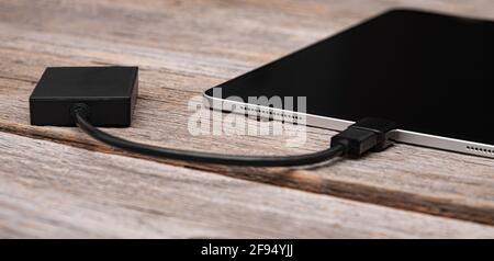 Memory card or external hard drive is connected to the Tablet PC. Stock Photo