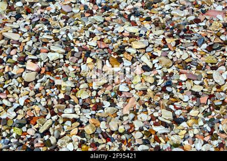 Background of colored wet small pebbles. Close up. Stock Photo
