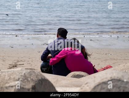 Young couple sitting on the Mahim Bay beach in Mumbai,  Maharashtra,India, Asia. Stock Photo