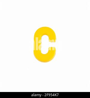 Letter D in yellow color - Plastic part Stock Photo - Alamy