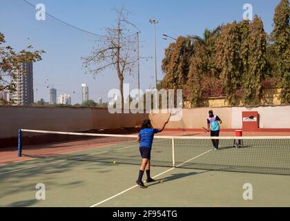 Young boy having tennis lesson with a coach at the SPG (Shivaji Park  Gymkhana) Tennis Academy in Mumbai,Maharashtra, India. Stock Photo