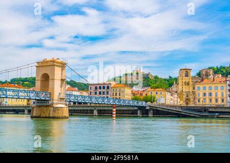 Cathedral in Vienne viewed behind a pedestrian bridge over river Rhone, France Stock Photo