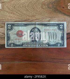 A two dollar bill isolated on a wood background. Stock Photo