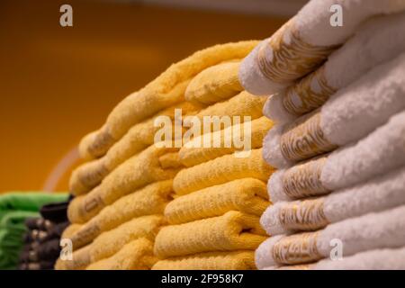 A stack of multi-colored bath towels close-up. Spa accessories for health care. Stock Photo