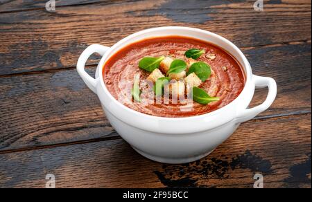 Bowl of tomato soup on wooden table with copy space Stock Photo