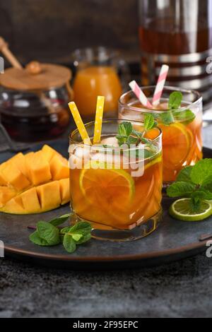 Mango iced tea with lime and mint. Refreshing organic soft drink Stock Photo