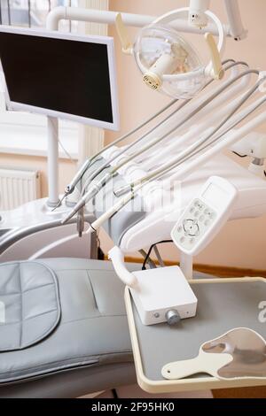 Dental treatment device for patients. The workplace of a professional dentist. Healthy teeth. Dental office with nobody in Stock Photo