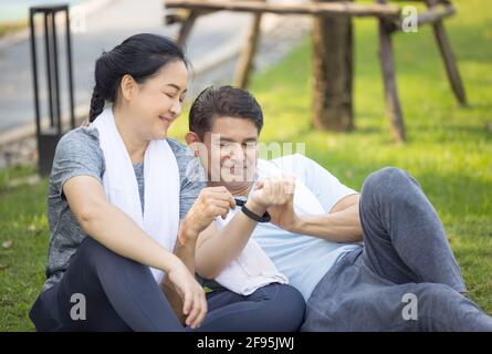 Couple doing stretching exercise after jogging Stock Photo