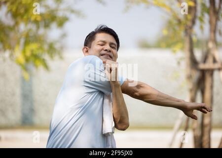 Sport men doing body warm up shoulder arm stretching muscle relax prepare for run and exercise Stock Photo