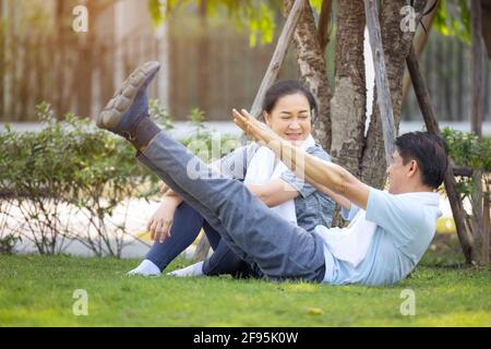 Couple doing stretching exercise after jogging Stock Photo