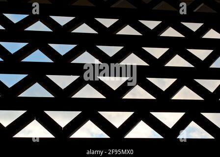 Balinese triangle pattern design in shadows with sky with clouds in the background. Stock Photo