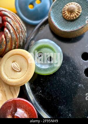 Multi-colored antique or vintage sewing buttons: Celluloid Buttons, Bakelite Buttons, Lucite Buttons, vegetable Ivory, metal, china, glass, plastic Stock Photo
