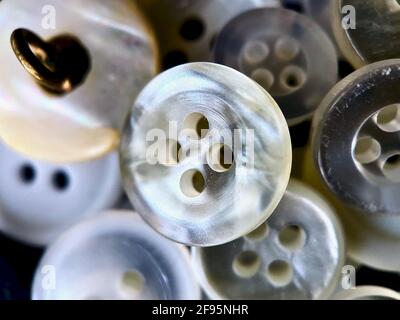 White, off-white and cream antique or vintage sewing buttons: Celluloid Buttons, Bakelite Buttons, Lucite Buttons, faux ivory, metal, China, glass Stock Photo