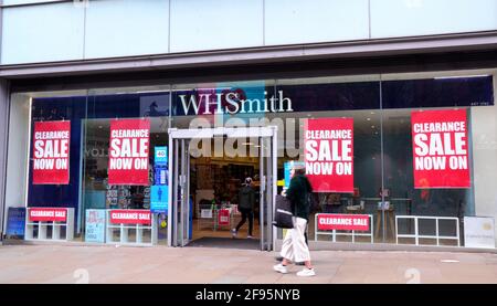 A W H Smith store or shop in Market Street, Manchester, Greater Manchester, England, United Kingdom, which displays 'clearance sale' posters on April 16th, 2021. The media report several other W H Smith stores in England are currently having clearance sales. The Covid 19 or Coronavirus lockdown has hit bricks and mortar stores hard. In November 2020 W H Smith reported a pretax loss of £226 million, compared with a profit of £135 million in 2019. Stock Photo