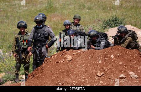 Nablus, Mideast. 16th Apr, 2021. Members of the Israeli border police and Israeli soldiers are seen during clashes following a protest against the expansion of Jewish settlements in the West Bank village of Beit Dajan, east of Nablus, on April 16, 2021. Credit: Ayman Nobani/Xinhua/Alamy Live News Stock Photo