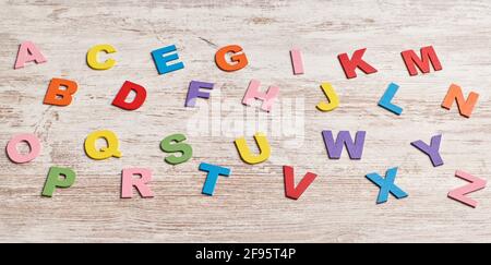 Colors alphabet letters in a clear wood background Stock Photo