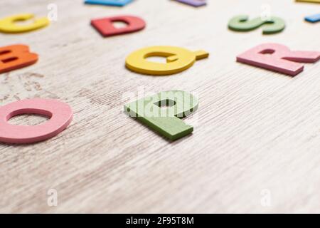 Colors alphabet letters in a clear wood background Stock Photo