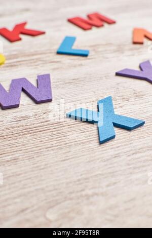 Colors alphabet letters in a clear wood background Stock Photo