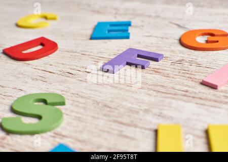 Colors alphabet letters in a clear wood background Stock Photo