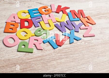 Colors alphabet letters in a clear wood background Stock Photo