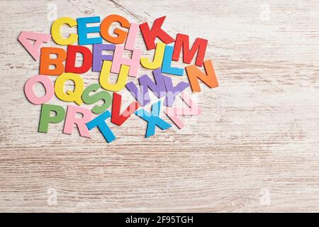 Colors alphabet letters in a clear wood background Stock Photo