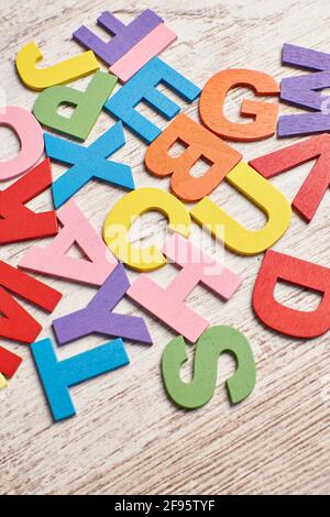 Colors alphabet letters in a clear wood background Stock Photo